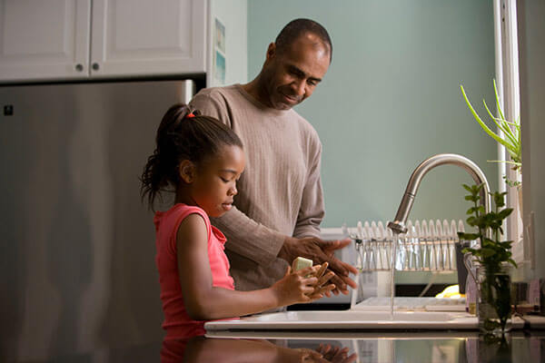 Father and daughter at sink